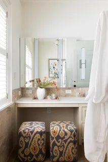 a bathroom with a double vanity sink and a mirror