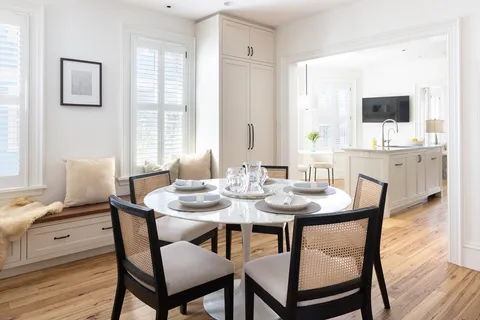 a view of a dining room with furniture and wooden floor