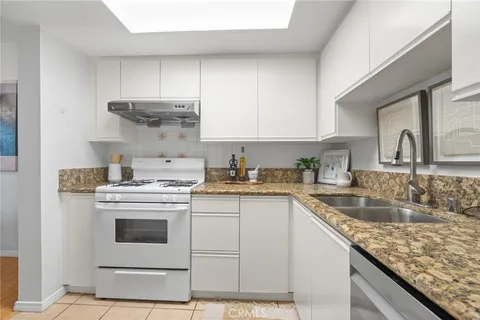a utility room with cabinets washer and dryer