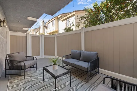 a outdoor living room with furniture and a window