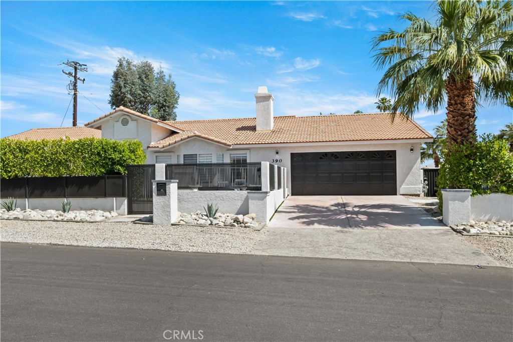 390 West Cortez Road Palm Springs, CA 92262 - Photo 1 of 1 a front view of a house with a garden