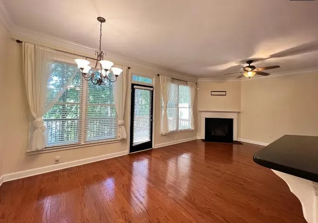 a view of an empty room with a fireplace and a window