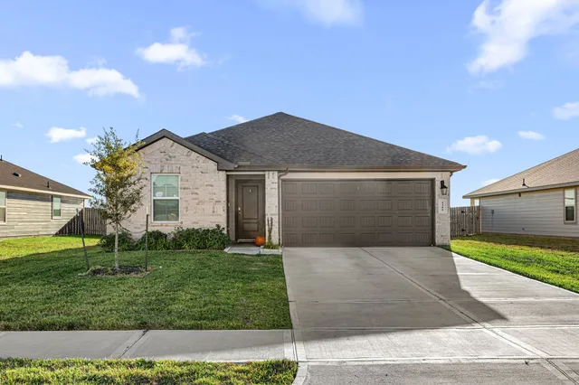 a front view of house with yard and trees
