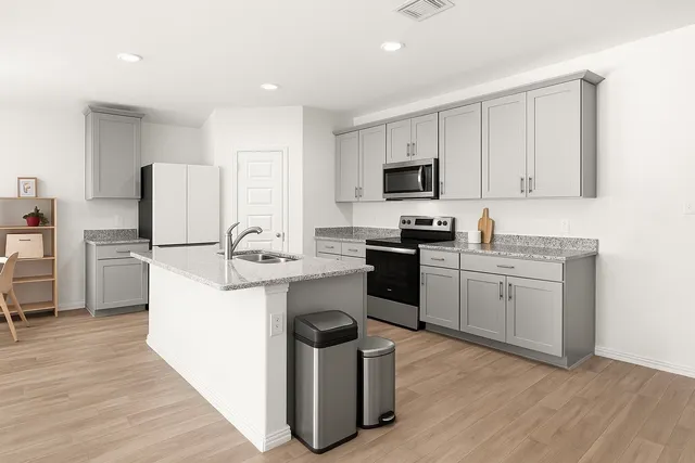 a kitchen with a sink cabinets and stainless steel appliances