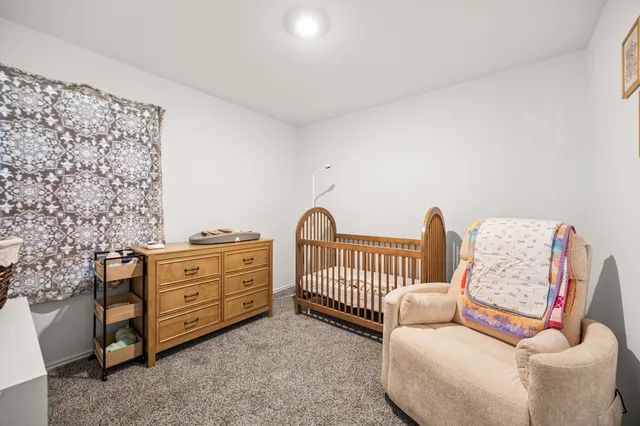 a bedroom with furniture and wooden floor