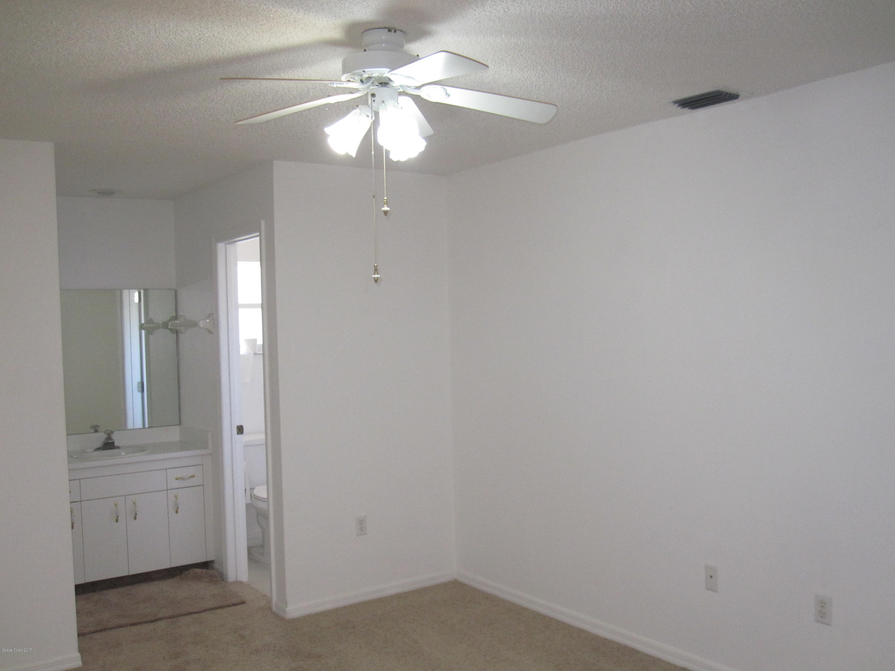 171 Americana Boulevard Northeast Palm Bay, FL 32907 - Photo 12 of 17 wooden floor in an empty room