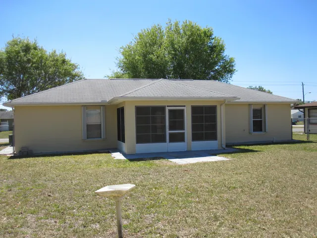 a front view of a house with a garden and yard