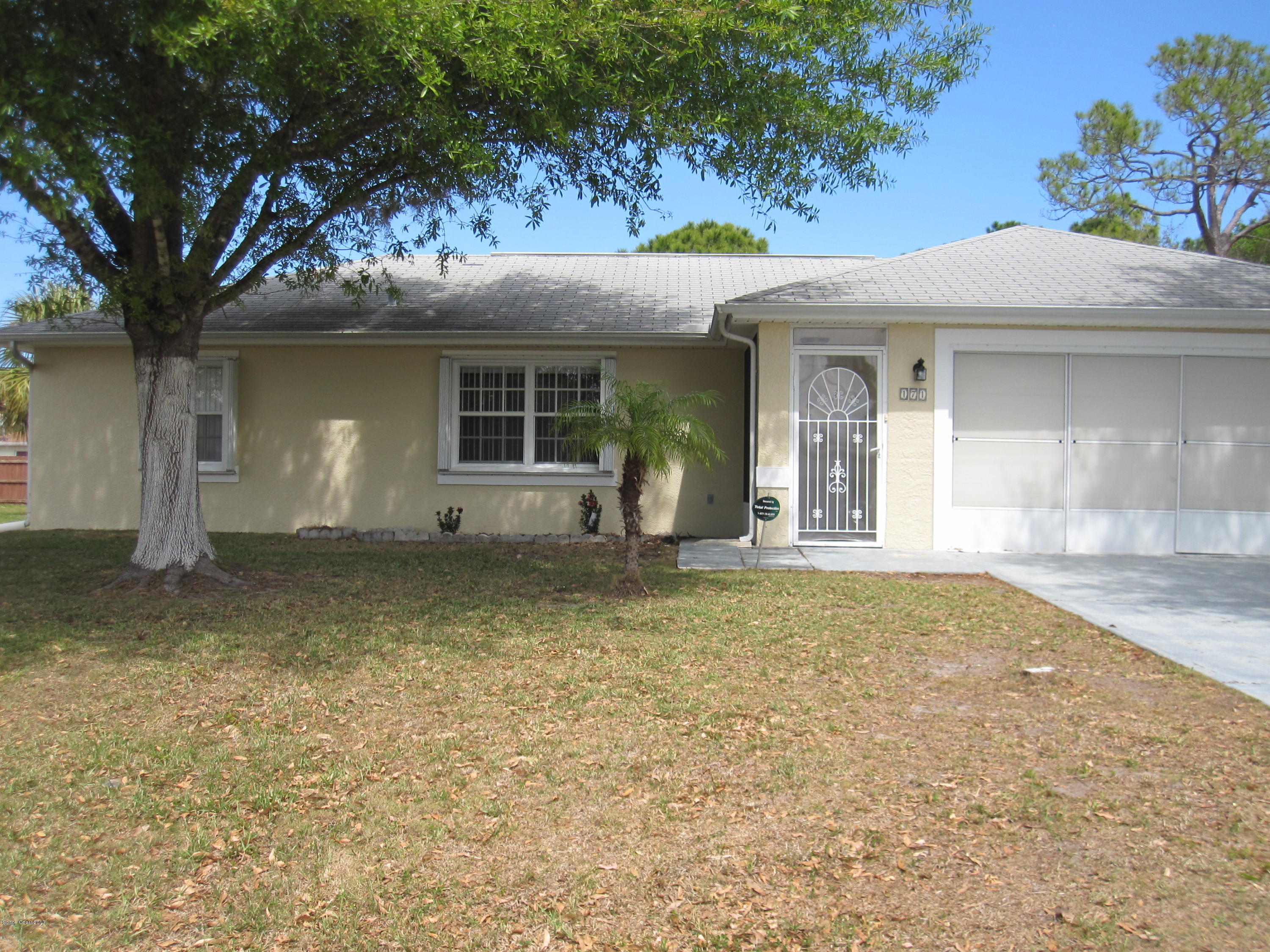 171 Americana Boulevard Northeast Palm Bay, FL 32907 - Photo 2 of 17 front view of a house with a yard