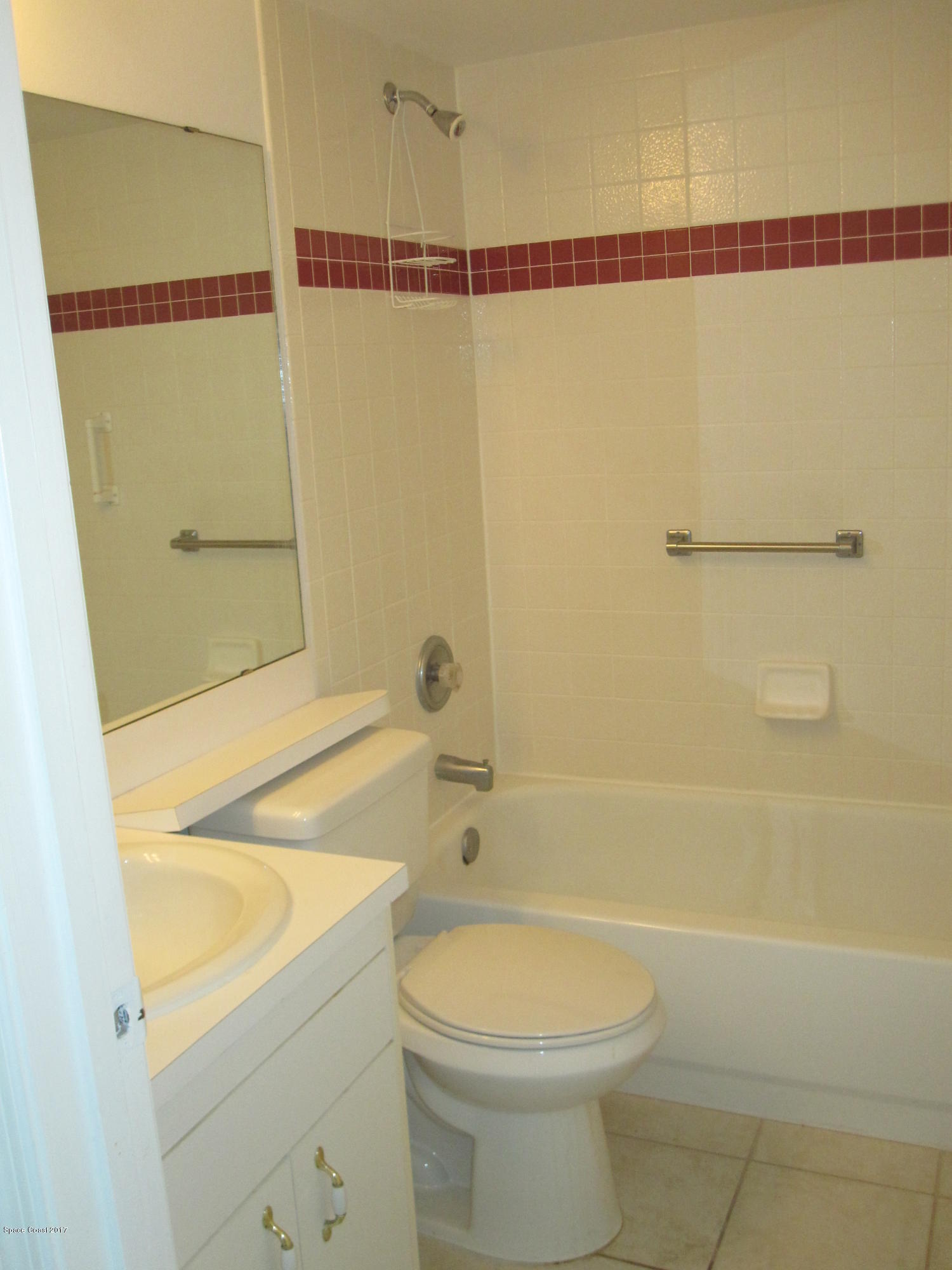 171 Americana Boulevard Northeast Palm Bay, FL 32907 - Photo 10 of 17 a bathroom with a sink a toilet and shower