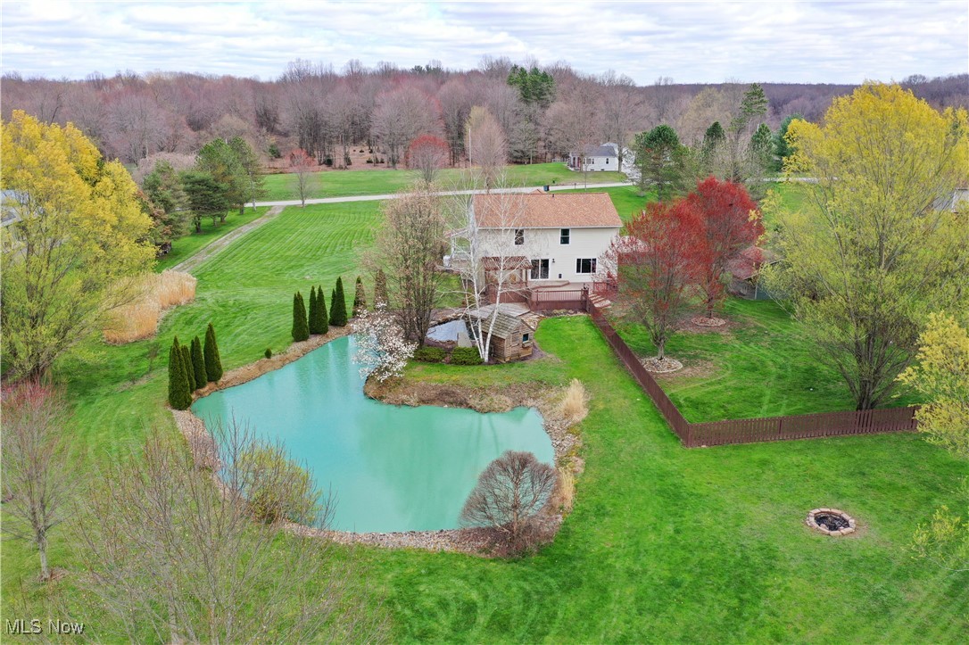 11215 Bloom Road Garrettsville, OH 44231 - Photo 2 of 42 The backyard hosts lush mature trees, and an expansive green space. The fenced backyard provides added privacy.