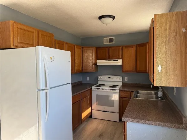a kitchen with a refrigerator sink and stove