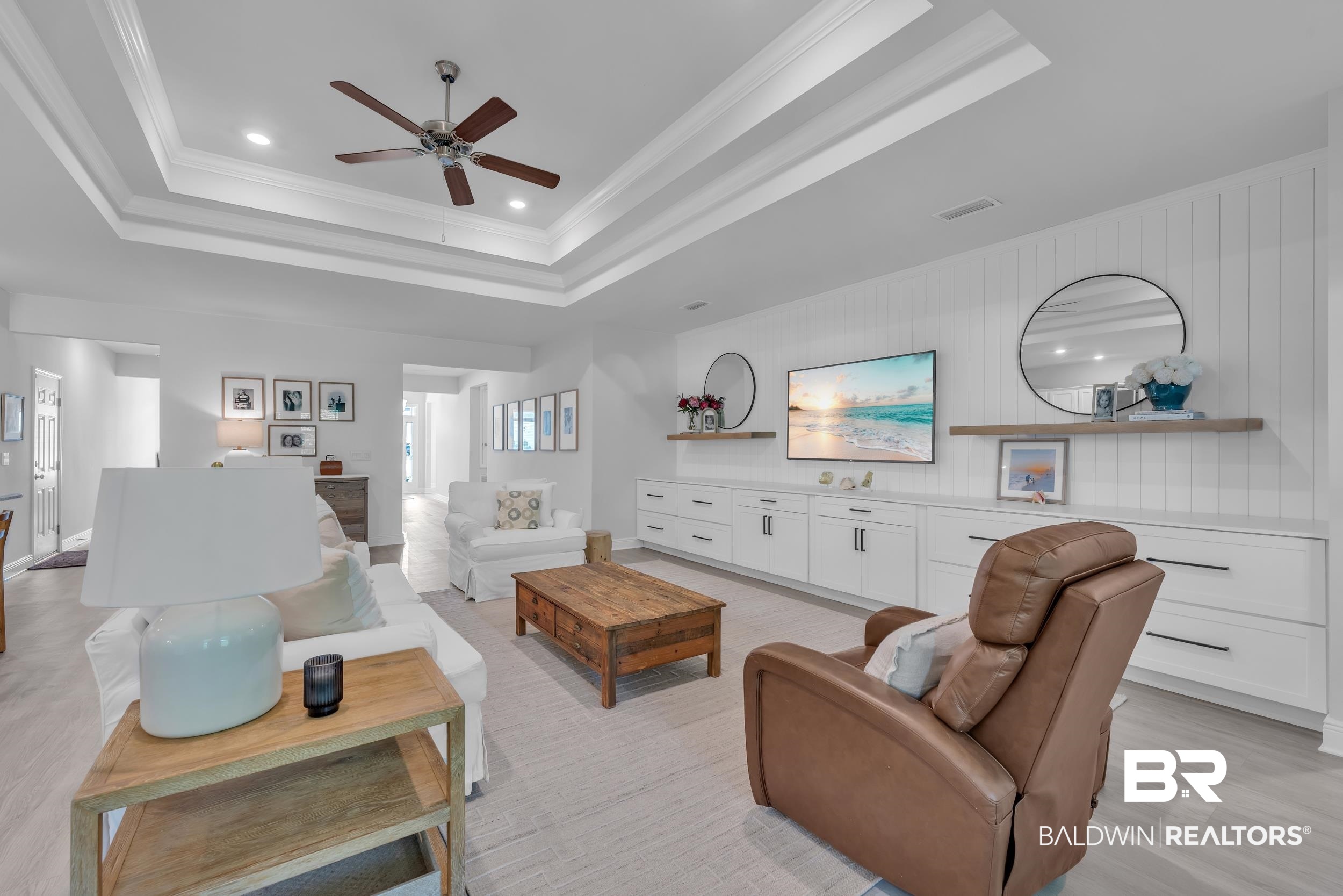 8774 Primland Boulevard Foley, AL 36535 - Photo 5 of 49 Living room featuring a tray ceiling, crown molding, recessed lighting, ceiling fan, and light wood-style flooring