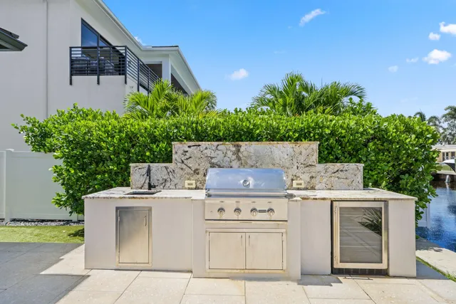 a kitchen with granite countertop white cabinets and a sink