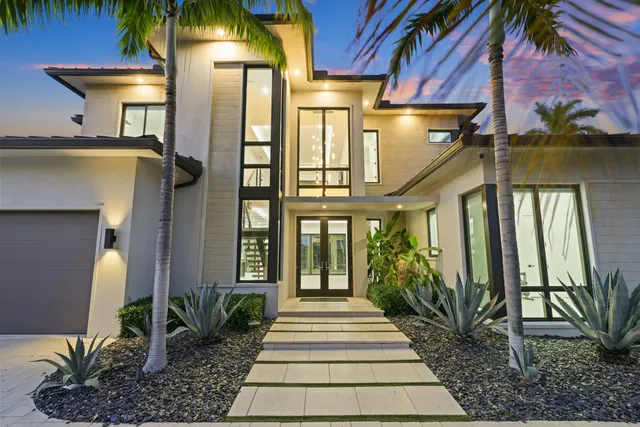a view of swimming pool with palm trees