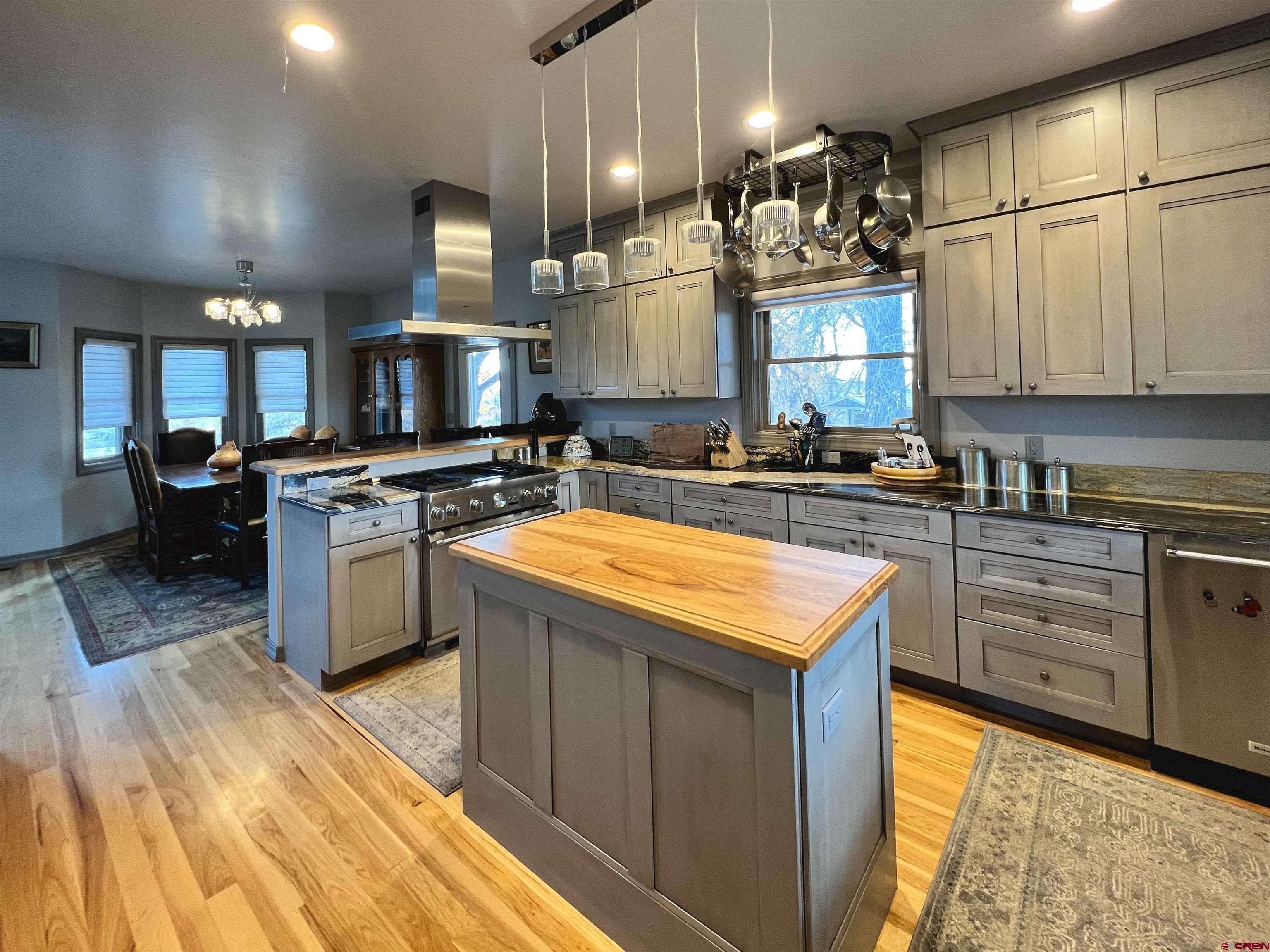 25286 Rd T.5 Dolores, CO 81323 - Photo 23 of 44 a kitchen with stainless steel appliances granite countertop a stove a sink dishwasher and a microwave oven with large trees