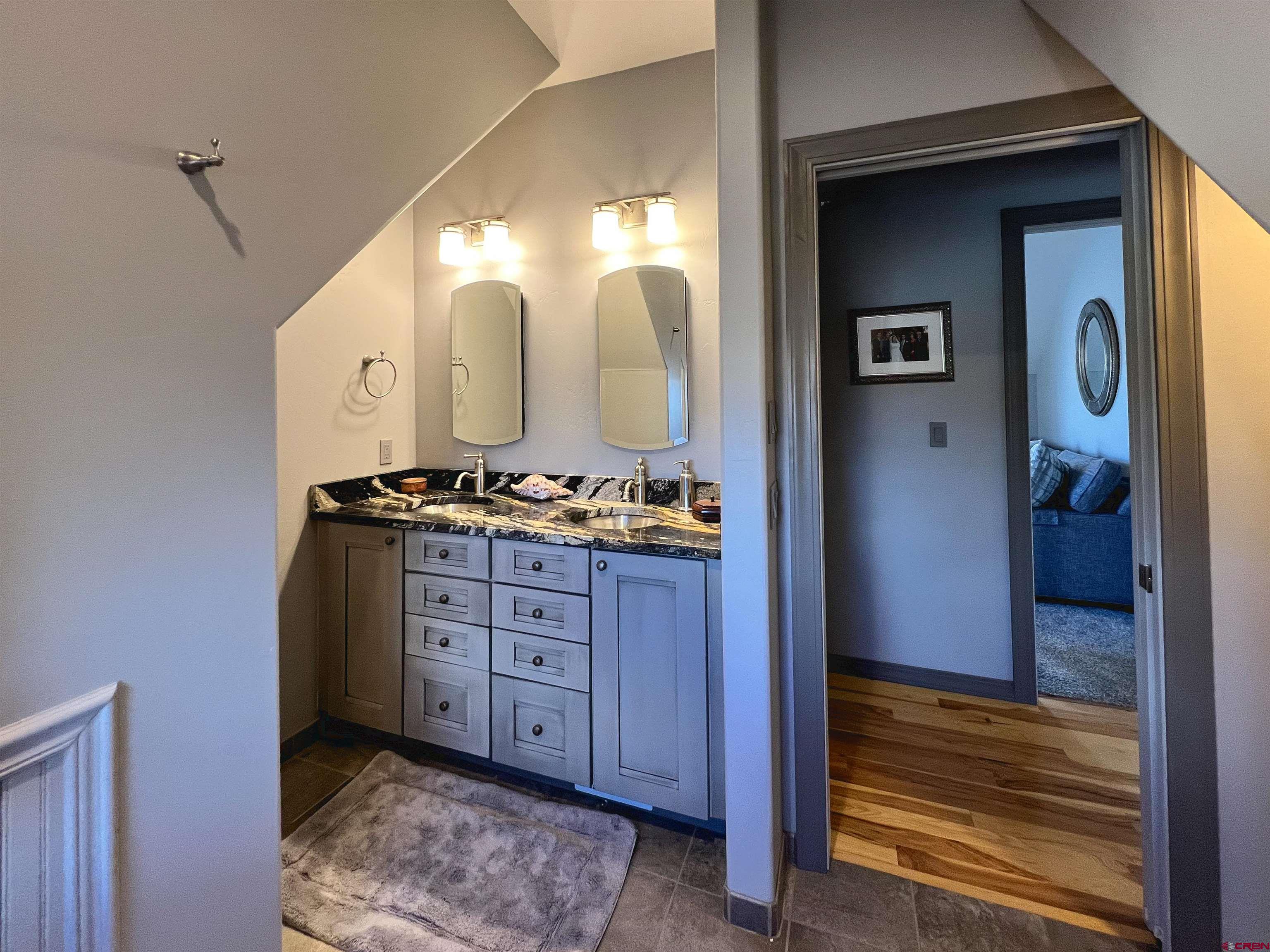 25286 Rd T.5 Dolores, CO 81323 - Photo 32 of 44 a spacious bathroom with a granite countertop sink and a mirror