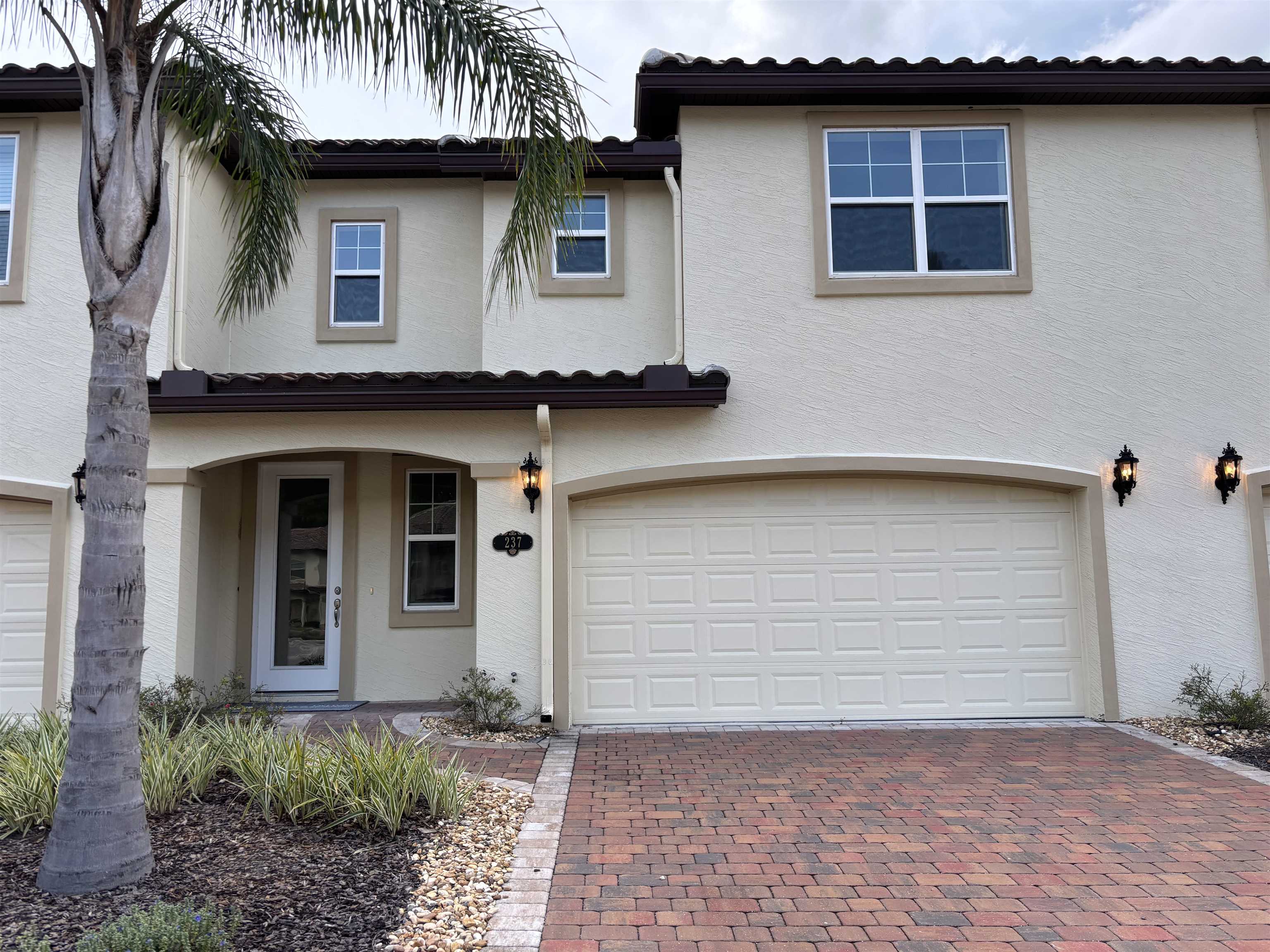 a front view of a house with garage
