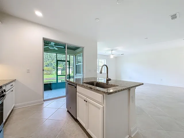 a kitchen that has a sink and a stove