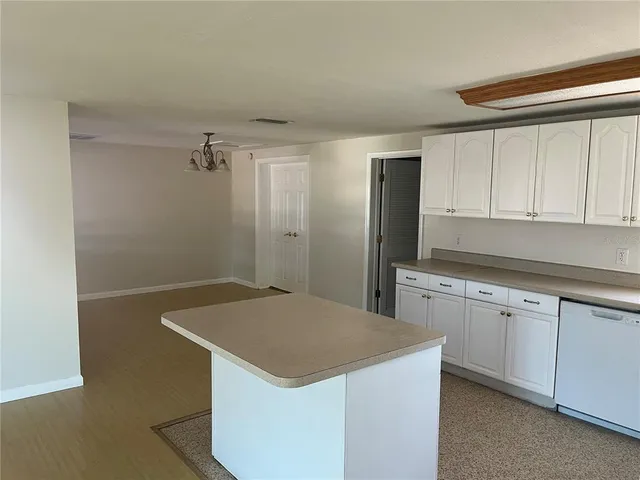 a kitchen that has a sink and a stove in it