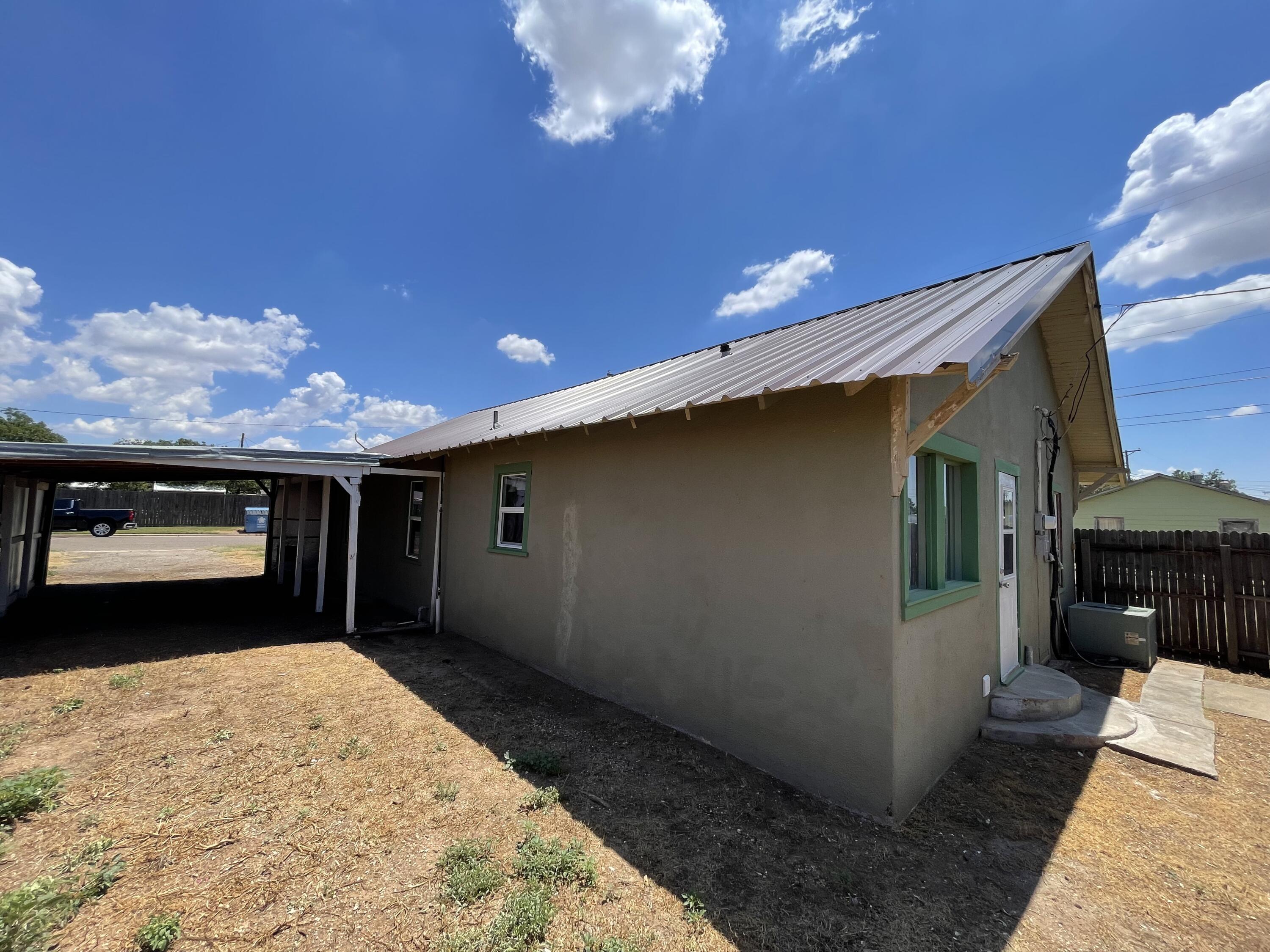 325 South 13th Street Slaton, TX 79364 - Photo 14 of 35 a view of a porch with furniture and a yard
