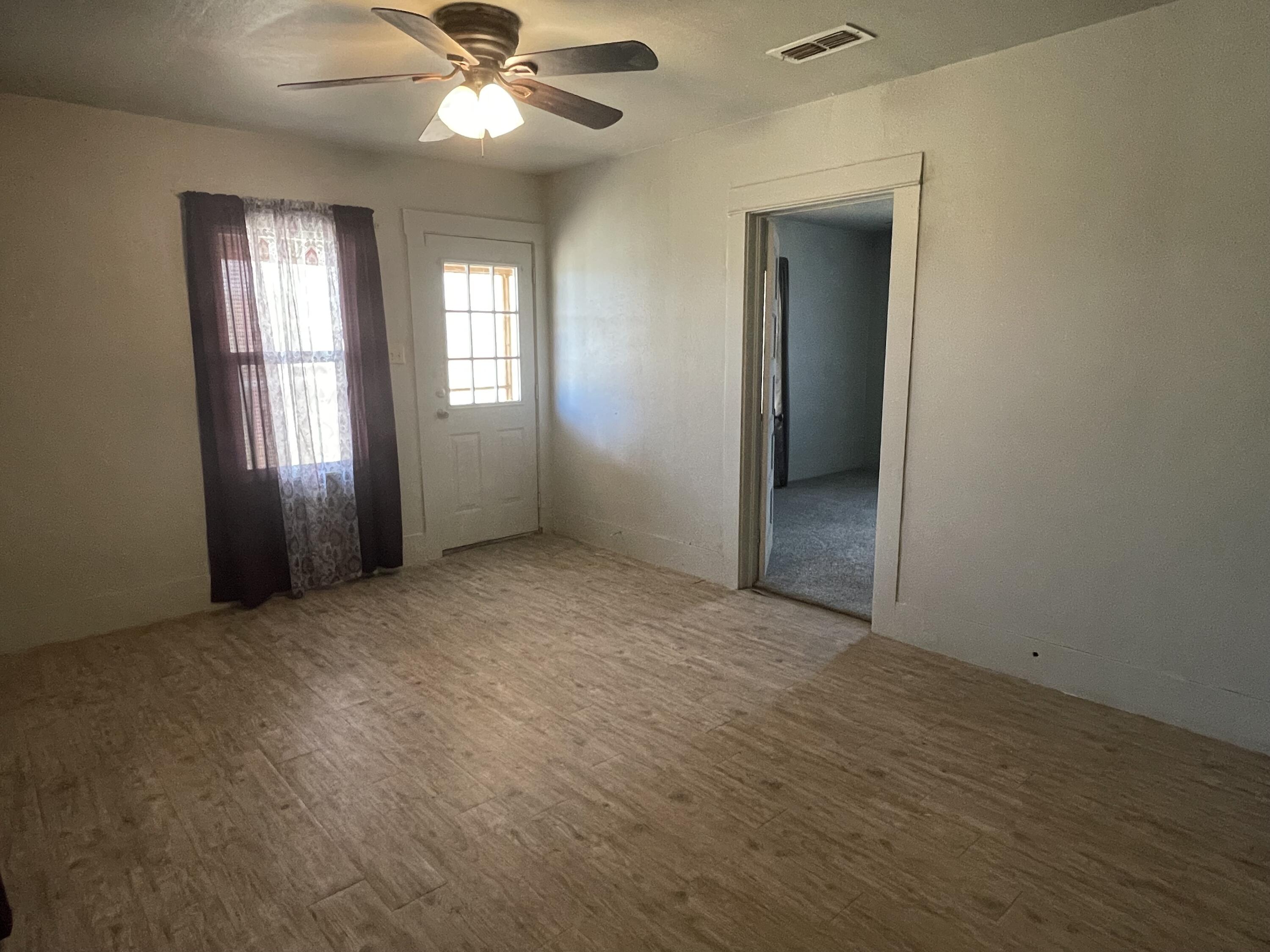 325 South 13th Street Slaton, TX 79364 - Photo 20 of 35 an empty room with closet and windows