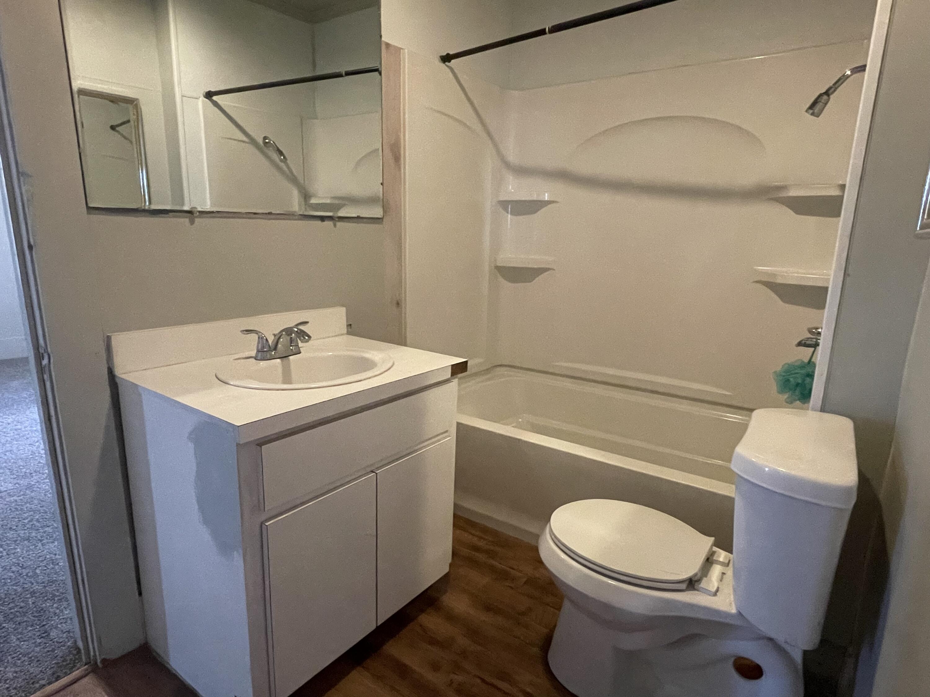 325 South 13th Street Slaton, TX 79364 - Photo 28 of 35 a bathroom with a sink mirror vanity and toilet