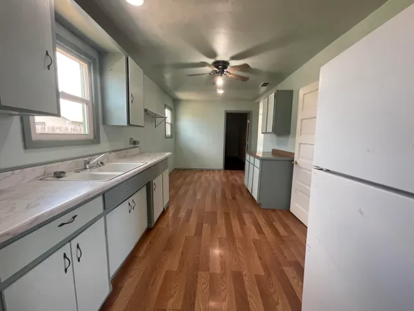 a spacious bathroom with a double vanity sink a mirror and a shower