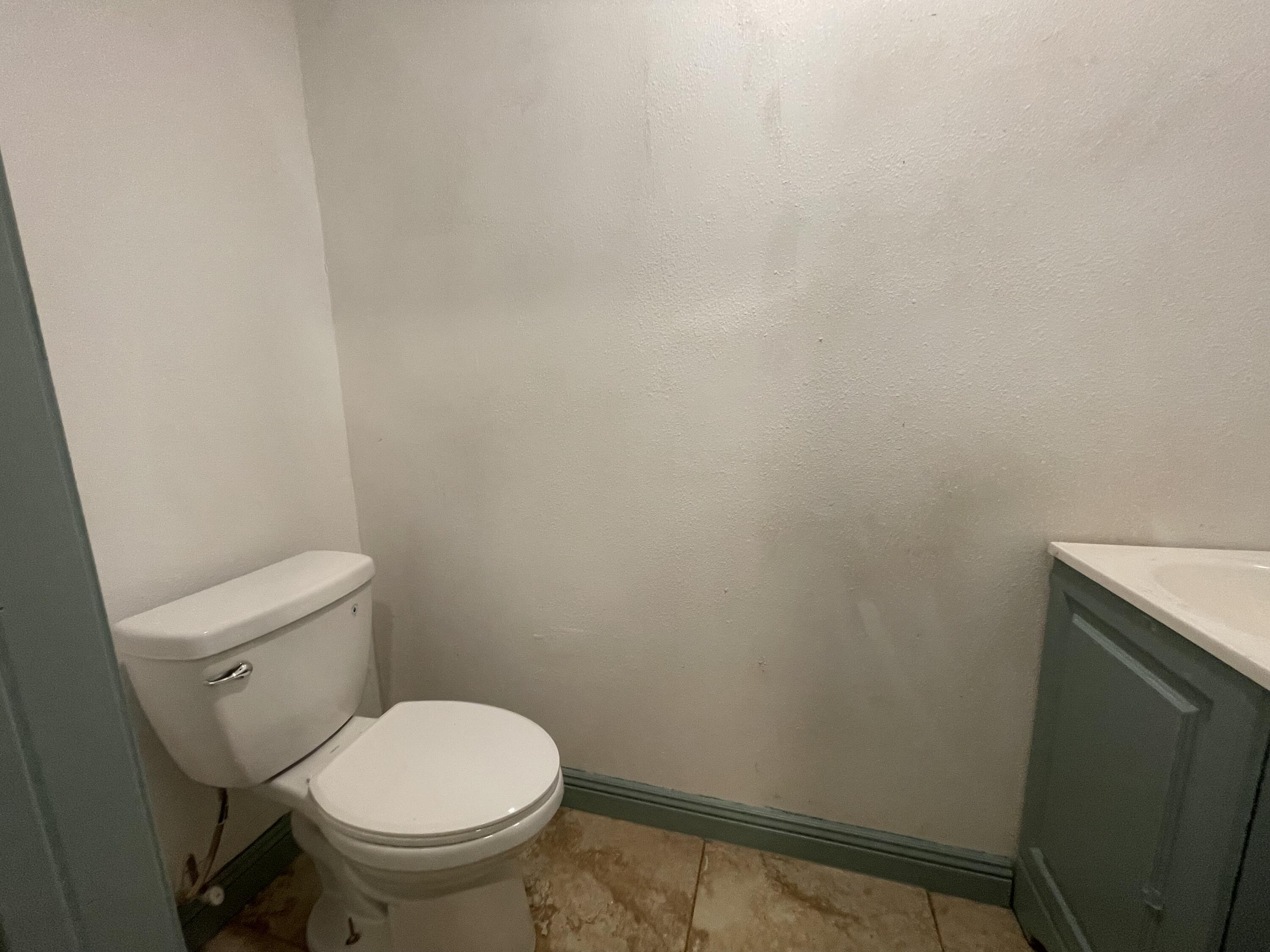 325 South 13th Street Slaton, TX 79364 - Photo 9 of 35 a white toilet sitting next to a shower