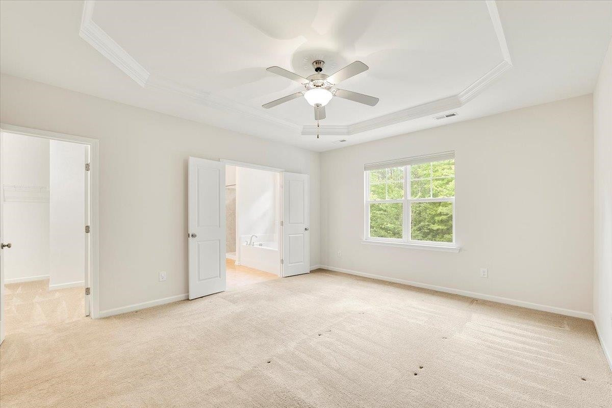 203 Zante Currant Road Durham, NC 27703 - Photo 12 of 28 A grand entrance to the ensuite bathroom and large walk in closet. Primary Bedroom