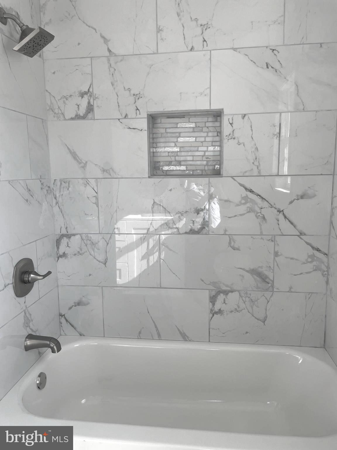 6107 Buckler Road Clinton, MD 20735 - Photo 19 of 45 a bathroom with a bathtub and shower
