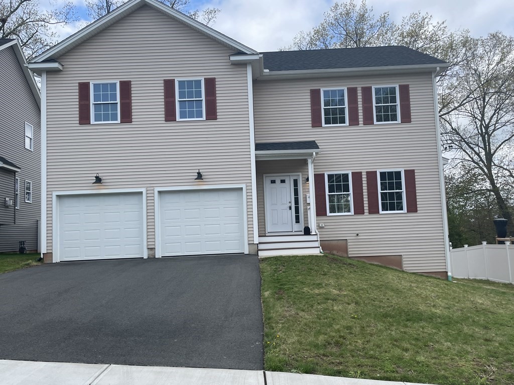 160 Canterbury Road Springfield, MA 01118 - Photo 2 of 20 a front view of a house with a garden and yard