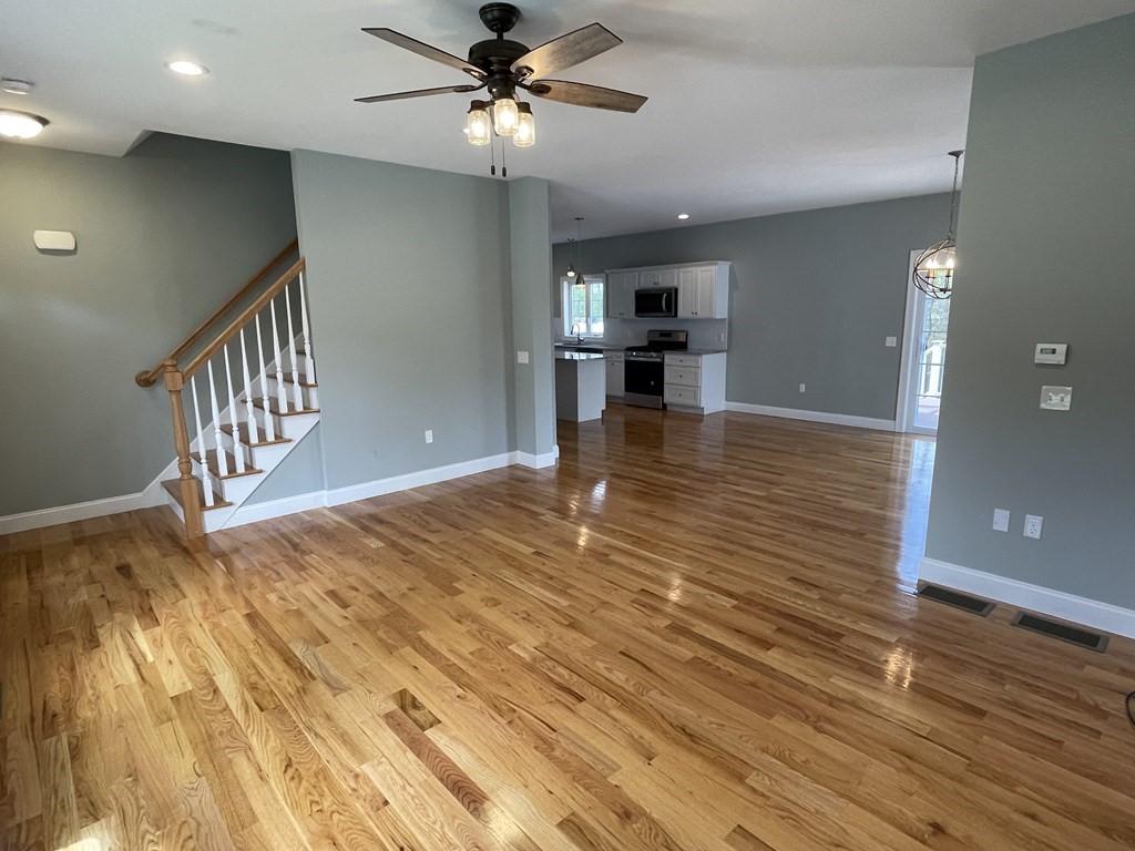 160 Canterbury Road Springfield, MA 01118 - Photo 4 of 20 a view of kitchen and empty room with wooden floor