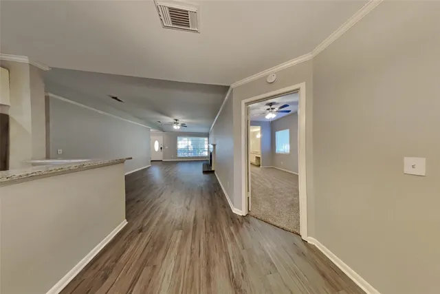 a view of hallway with wooden floor