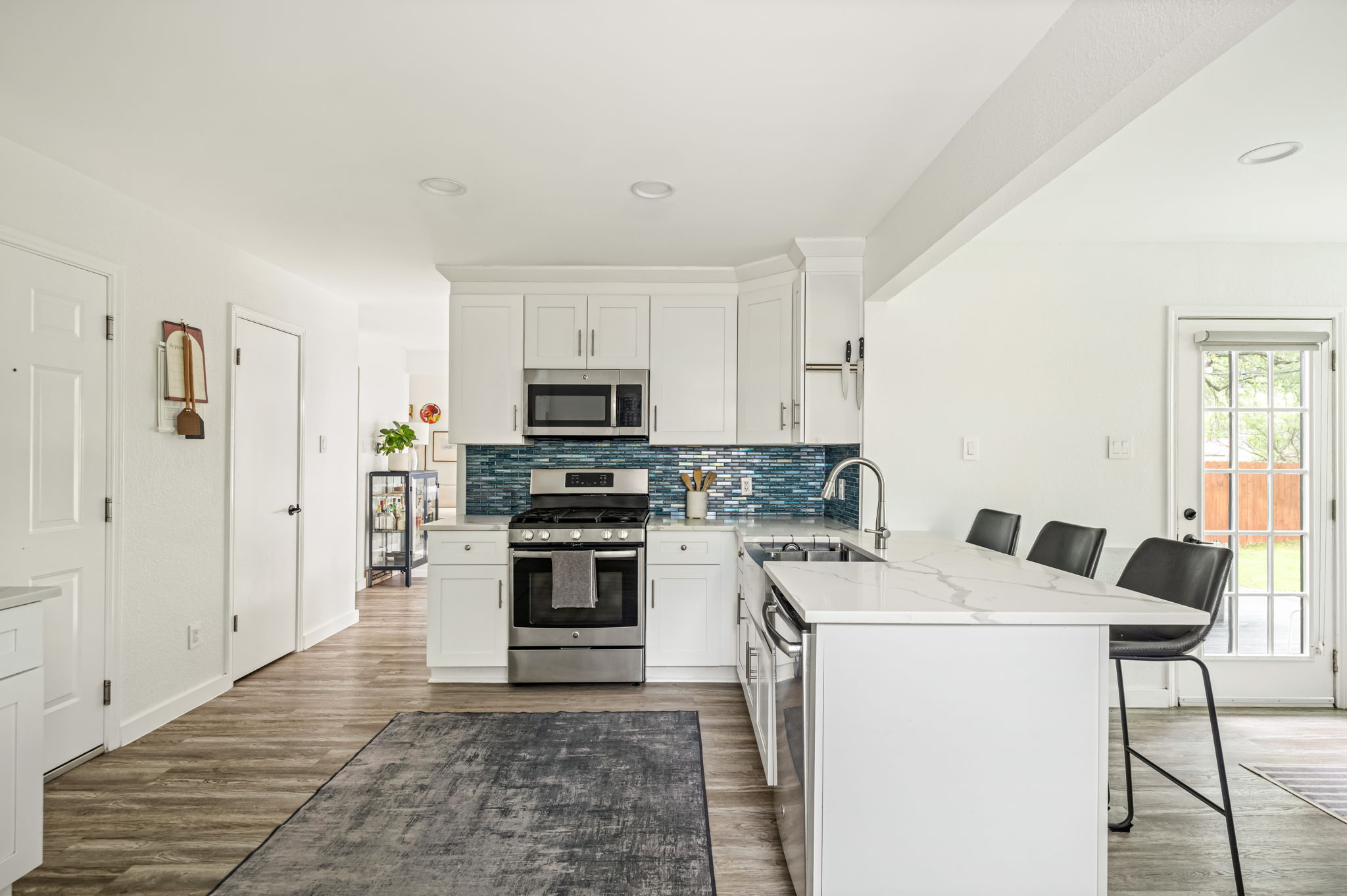 4506 Velasco Place Austin, TX 78749 - Photo 11 of 35 a kitchen with a stove a sink and a refrigerator