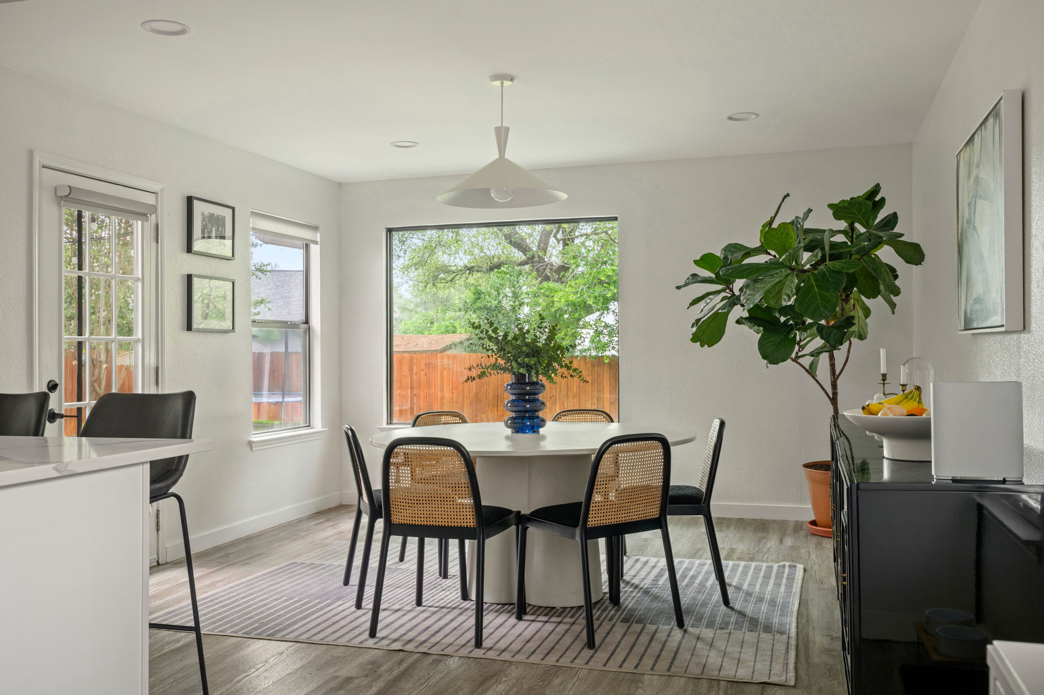 4506 Velasco Place Austin, TX 78749 - Photo 13 of 35 a dining room with furniture potted plants and wooden floor