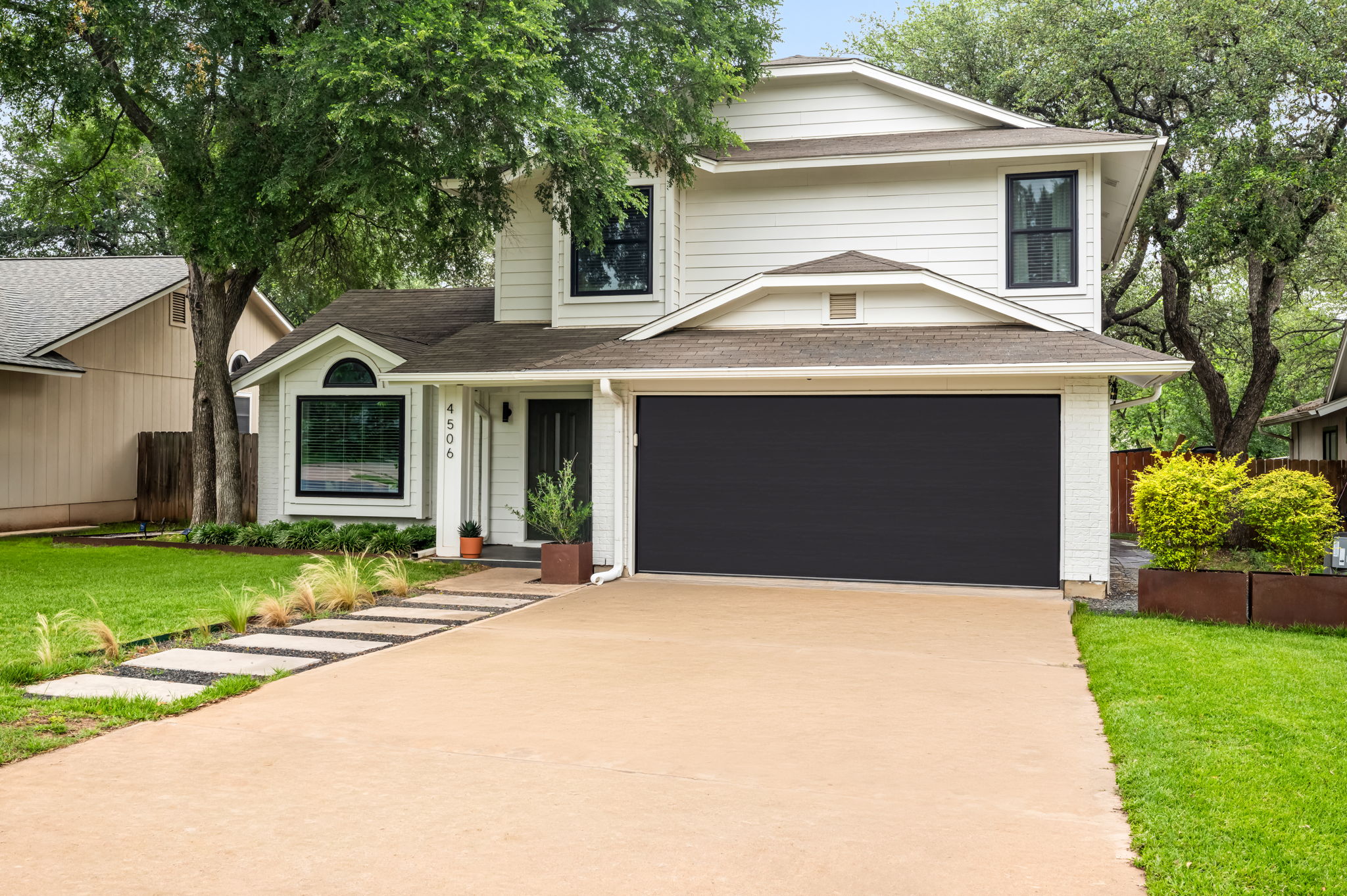 4506 Velasco Place Austin, TX 78749 - Photo 2 of 35 a front view of a house with a garden and trees