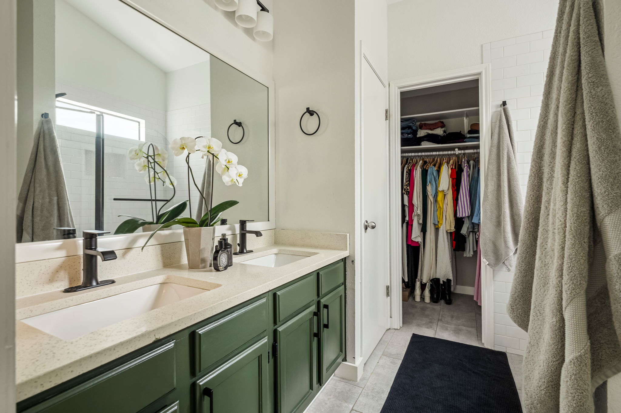 4506 Velasco Place Austin, TX 78749 - Photo 27 of 35 a en suite bathroom with a double vanity sink and a mirror