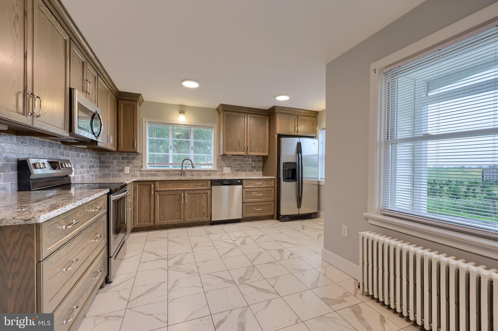 145 Weaver Road Lancaster, PA 17603 - Photo 22 of 87 a kitchen with stainless steel appliances granite countertop a stove a sink and a refrigerator