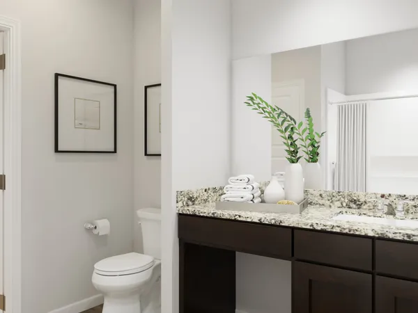 a bedroom with a bed and a potted plant