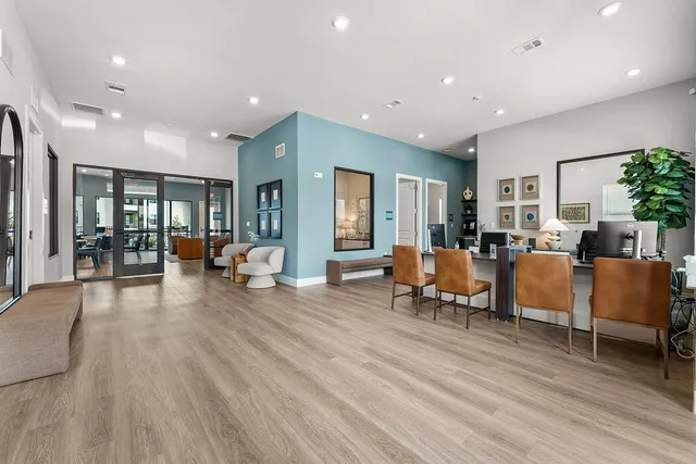 a living room with furniture and a wooden floor