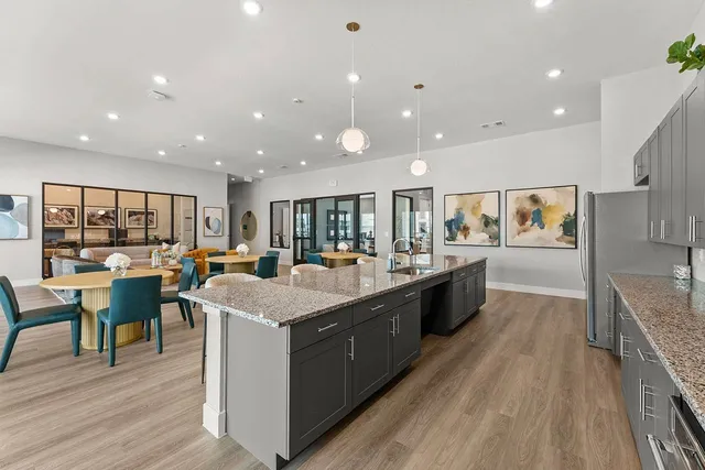 a large kitchen with stainless steel appliances lots of counter top space