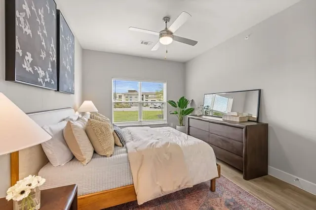 a bedroom with a large bed and a window