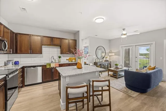 a kitchen with granite countertop a sink and a stove