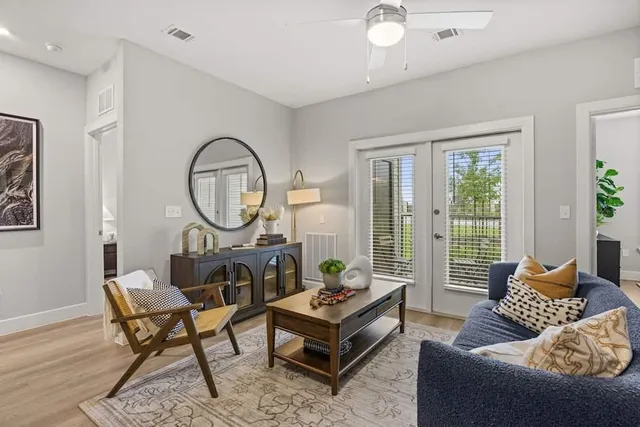 a living room with furniture and a large window