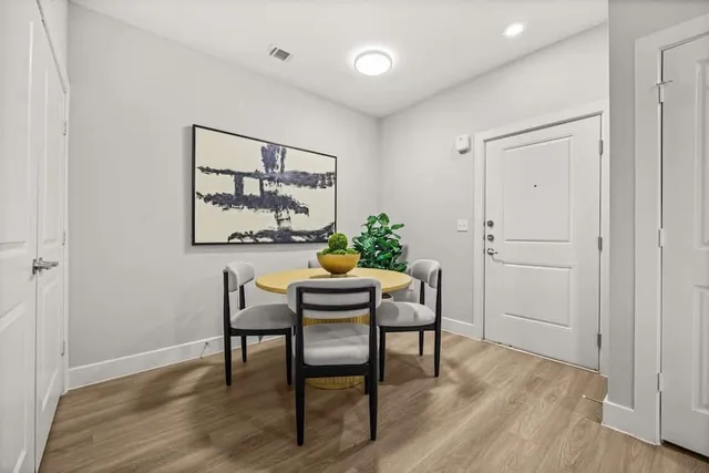 a view of a dining room with furniture and wooden floor