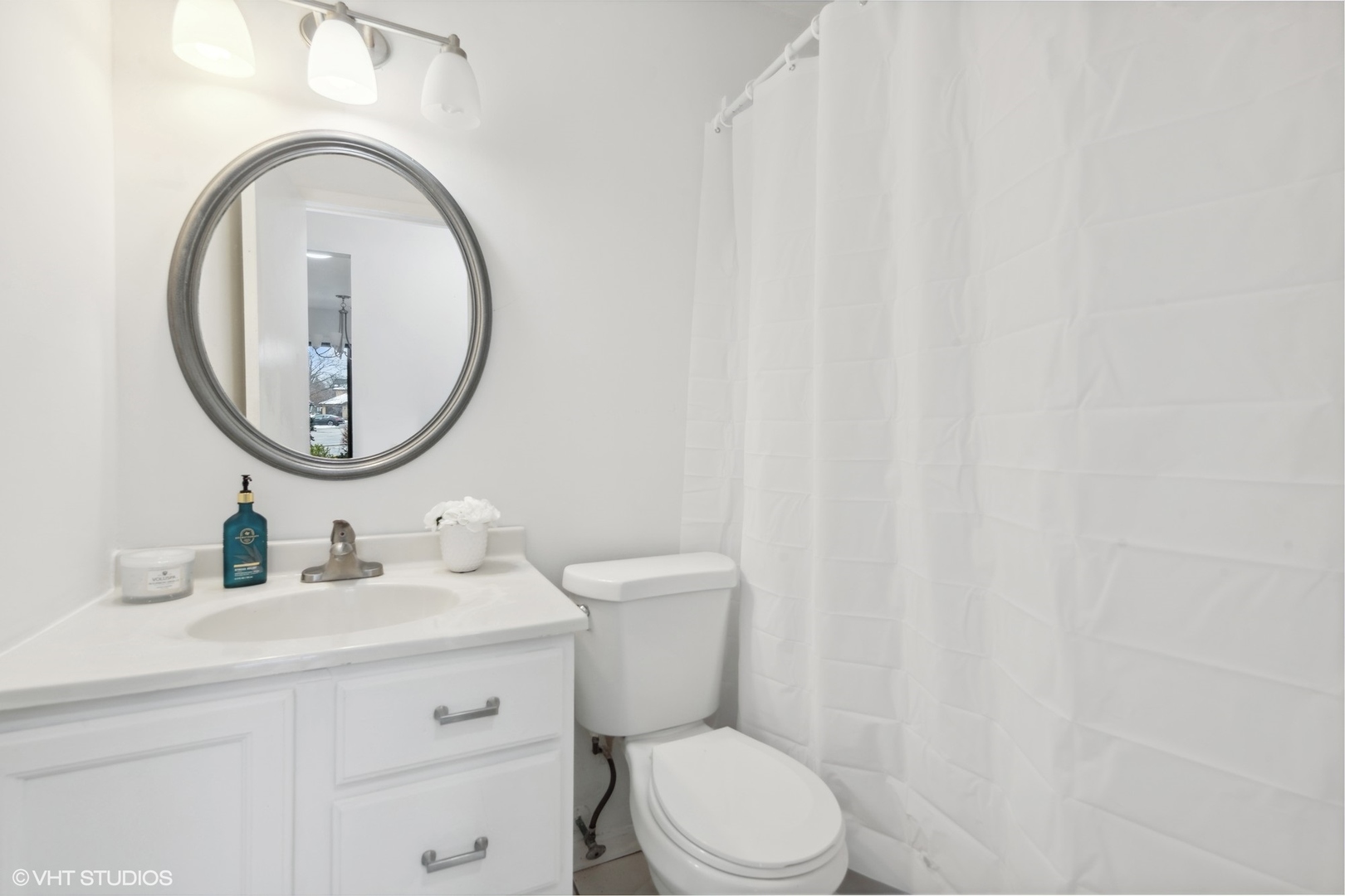 1400 North Elmhurst Road, Unit 103 Mount Prospect, IL 60056 - Photo 11 of 15 a bathroom with a sink a toilet and a mirror