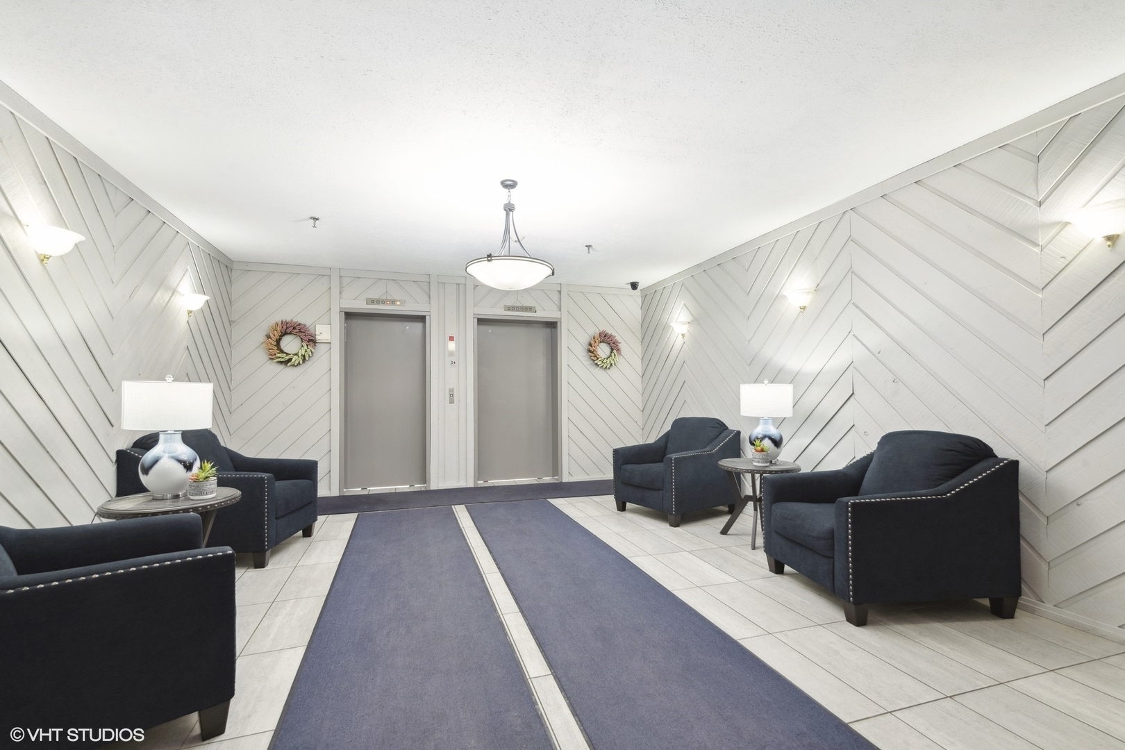 1400 North Elmhurst Road, Unit 103 Mount Prospect, IL 60056 - Photo 15 of 15 a living room with furniture and a chandelier