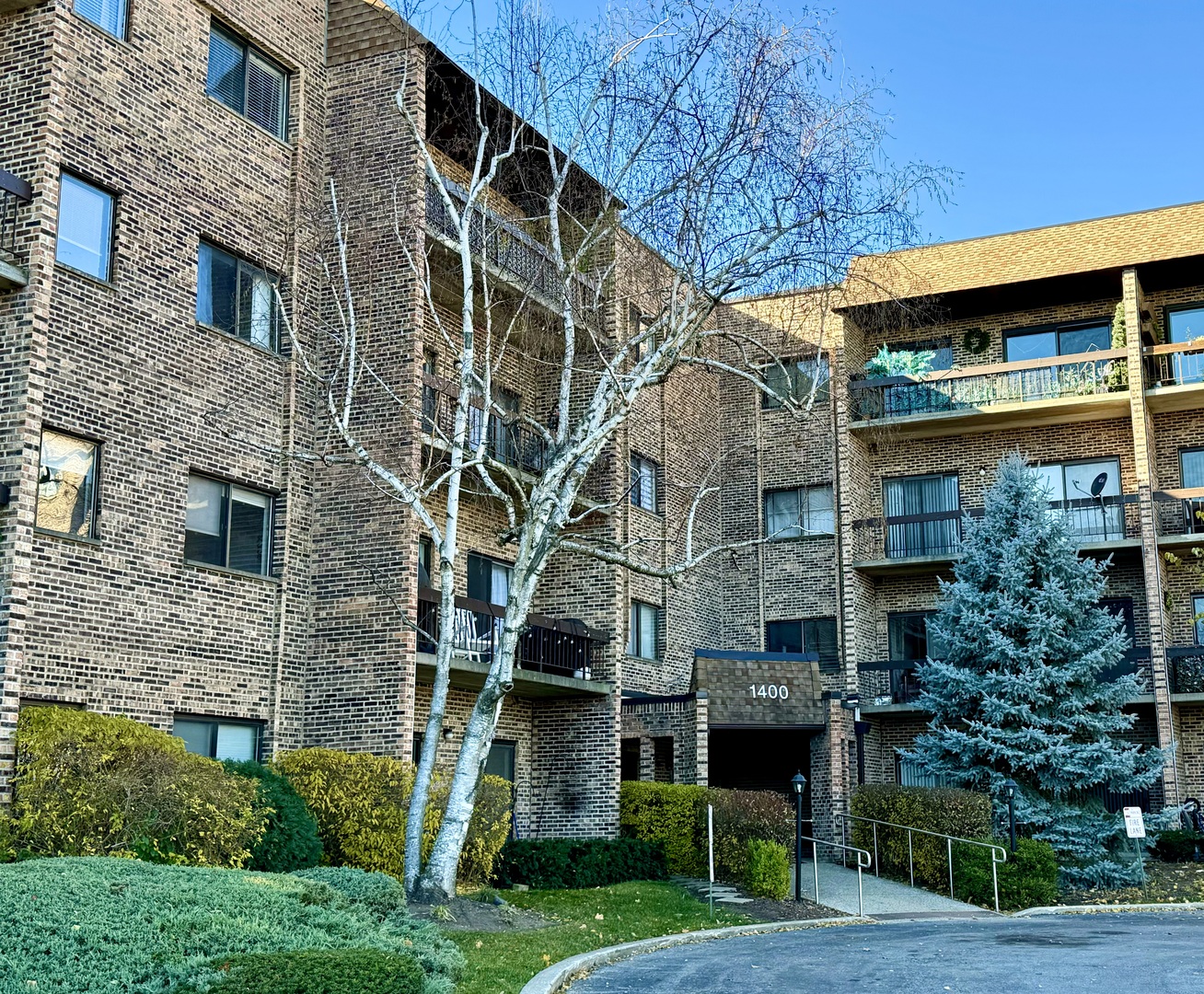 1400 North Elmhurst Road, Unit 103 Mount Prospect, IL 60056 - Photo 3 of 15 a view of a large building with a yard