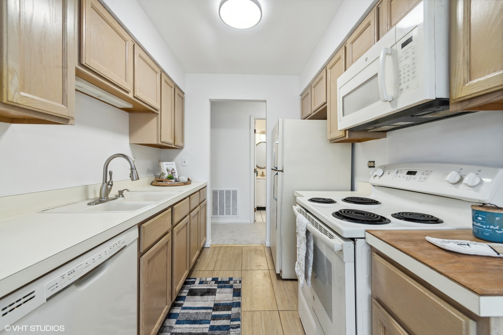 1400 North Elmhurst Road, Unit 103 Mount Prospect, IL 60056 - Photo 7 of 15 a kitchen with sink stove and cabinets