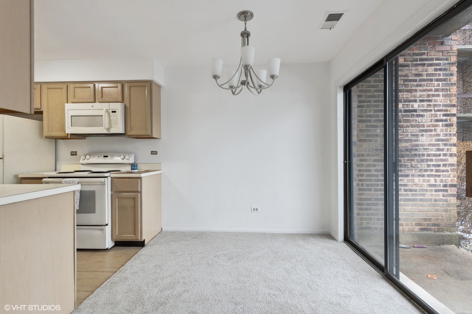 1400 North Elmhurst Road, Unit 103 Mount Prospect, IL 60056 - Photo 8 of 15 a kitchen with white cabinets and sink